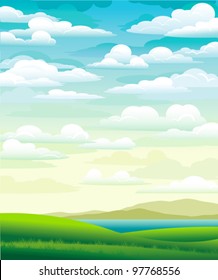 Summer landscape with green meadow and cloudy blue sky