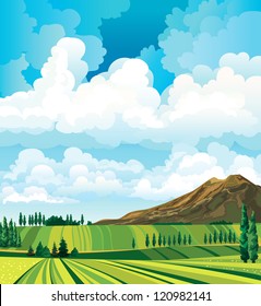 Summer landscape with green meadow, cypress, mountain and group of clouds on a blue sky background