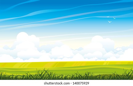 Summer landscape with green meadow and grass on a blue sky background with cumulus clouds