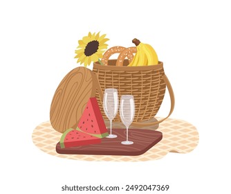 Summer picnic basket with fresh baked pretzel, banana and sliced watermelon on wooden tray