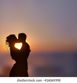 Summer poster with a kissing couple silhouette against contrast blue and yellow sunset seascape blurred background. Realistic vector illustration.