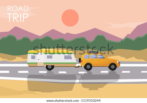 Summer road trip concept. Yellow car with\
a camper trailer riding on the road at\
sunset.