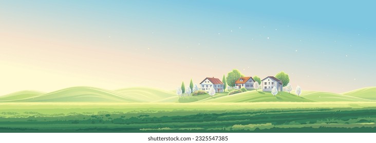 Summer rural landscape panoramic format, with village houses, and  field and hills illuminated by the sun.