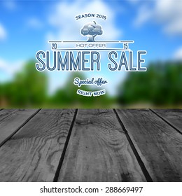 Summer sale and discounts badges. Against a blurred background of sky and a wooden table