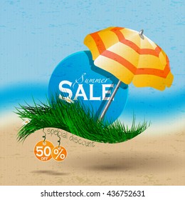 Summer sale.Caption discount on the blue circle placed on the grass under an umbrella on a background of the sea and the beach