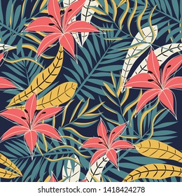 Summer seamless pattern with bright tropical leaves, plants and flowers on a dark background. Vector design. Jungle print. Textiles and printing. Floral background.