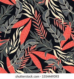 Summer seamless tropical pattern with bright yellow and red plants and leaves on a black background.  Vector design. Jungle print. Floral background.  
Tropic leaves in bright colors.