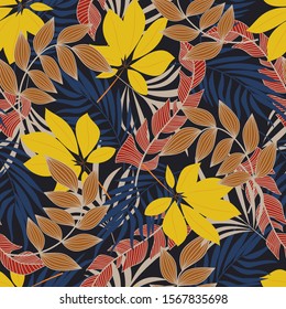 Summer seamless tropical pattern with bright yellow and red plants and leaves on a dark background. Vintage pattern.  Vector design. Jungle print. Floral background. 