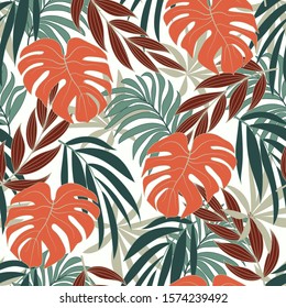 Summer seamless tropical pattern with bright orange and green plants and leaves on white background. Seamless pattern with colorful leaves and plants. Exotic jungle wallpaper. 