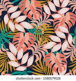 Summer seamless tropical pattern with bright yellow and pink plants and leaves on a black background. Beautiful print with hand drawn exotic plants.Seamless exotic pattern with tropical plants.