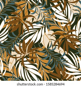 Summer seamless tropical pattern with bright blue and brown plants and leaves on a green background. Vector design. Jungle print. Floral background.  Tropic leaves in bright colors.