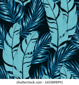 Summer seamless tropical pattern with bright leaves and plants on a dark background. Seamless exotic pattern with tropical plants. Tropical botanical.