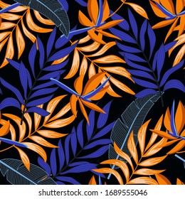 Summer seamless tropical pattern with bright leaves and plants on a dark background. 
Beautiful exotic plants.  Tropic leaves in bright colors. Colorful stylish floral.