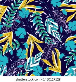 Summer trend seamless background with bright tropical leaves and flowers background. Vector design. Jungle print. Floral background. Printing and textiles. Exotic tropics. Summer design.
