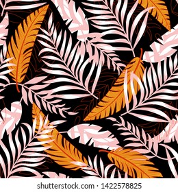 Summer trend seamless pattern with bright tropical leaves and plants on a dark background. Vector design. Jung print. Floral background. Printing and textiles.