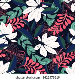 Summer trend seamless pattern with tropical leaves and plants on a dark background. Vector design. Jung print. Floral background. Printing and textiles.