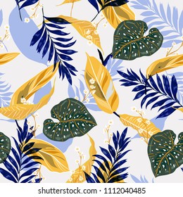 Summer and trendy tropical leaves. Seamless graphic design with palms leaves and flowers. Fashion,fabric and all prints on stylishlight blue background