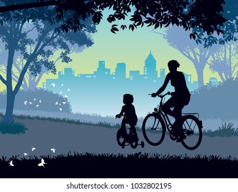 Summer trip. Happy mother and child cycling on a summer trip in the park.
