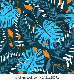 Summer tropical seamless pattern with bright leaves and plants on a green background. Vector design. Jungle print. Floral background.