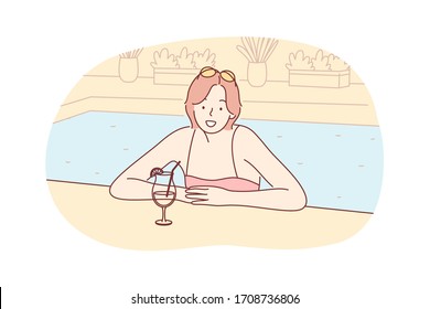 Summer vacation, holiday, rest, tourism, travelling concept. Woman girl tourist on holiday rest at hotel swimming pool with cocktail, looking straight at camera. Summer vacation at sea, ocean resort.