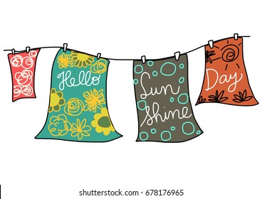 Summertime concept with clothes hanging on the clothesline with wording "Hello Sunshine Day" printed on each cloth. 