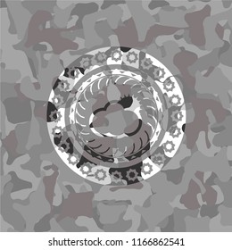 sun behind cloud icon inside grey camouflage texture