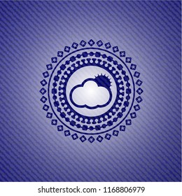 sun behind cloud icon inside emblem with denim texture