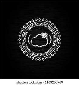 sun behind cloud icon inside chalkboard emblem written on a blackboard