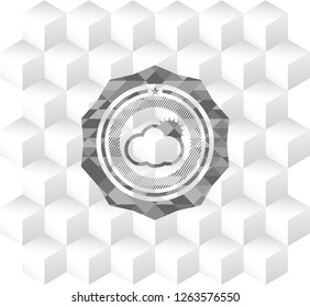 sun behind cloud icon inside grey badge with geometric cube white background