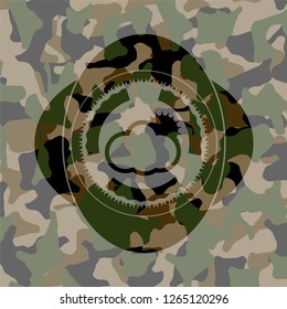 sun behind cloud icon inside camouflaged emblem