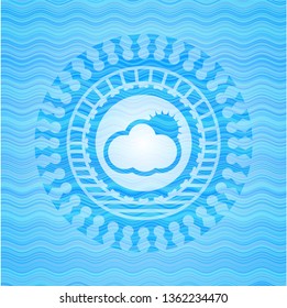 sun behind cloud icon inside water wave representation badge.