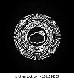 sun behind cloud icon inside chalkboard emblem on black board
