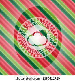 sun behind cloud icon inside christmas colors emblem.