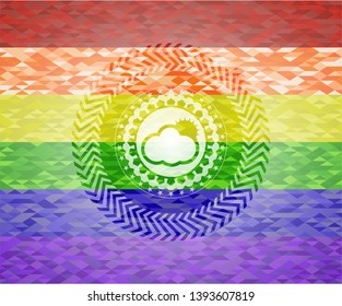 sun behind cloud icon inside emblem on mosaic background with the colors of the LGBT flag