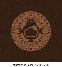 sun behind cloud icon inside wooden emblem