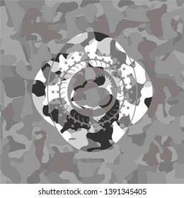 sun behind cloud icon on grey camouflage texture