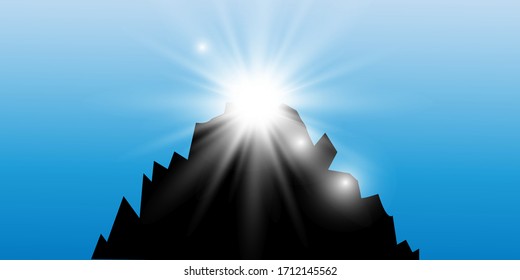 Sun flare over the black mountain. Sunrise.