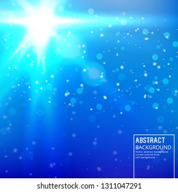 Sun Glare on Soft Blue Background. Abstract Background with Bokeh Effect.