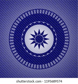 sun icon inside badge with denim background
