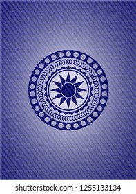 sun icon inside badge with denim background