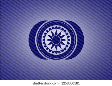 sun icon inside badge with denim texture