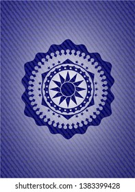 sun icon inside badge with denim texture