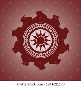 sun icon inside badge with red background