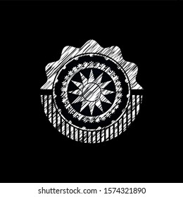 sun icon inside chalkboard emblem written on a blackboard