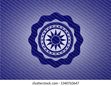 sun icon inside emblem with denim high quality background