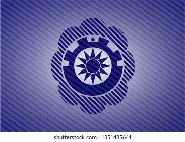 sun icon inside emblem with denim texture