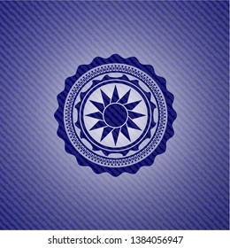 sun icon inside emblem with denim high quality background