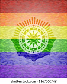 sun icon inside emblem on mosaic background with the colors of the LGBT flag