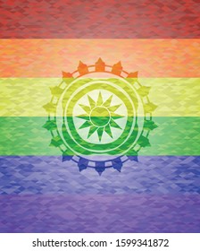 sun icon inside emblem on mosaic background with the colors of the LGBT flag