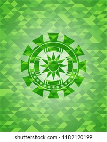 sun icon inside green emblem with mosaic background